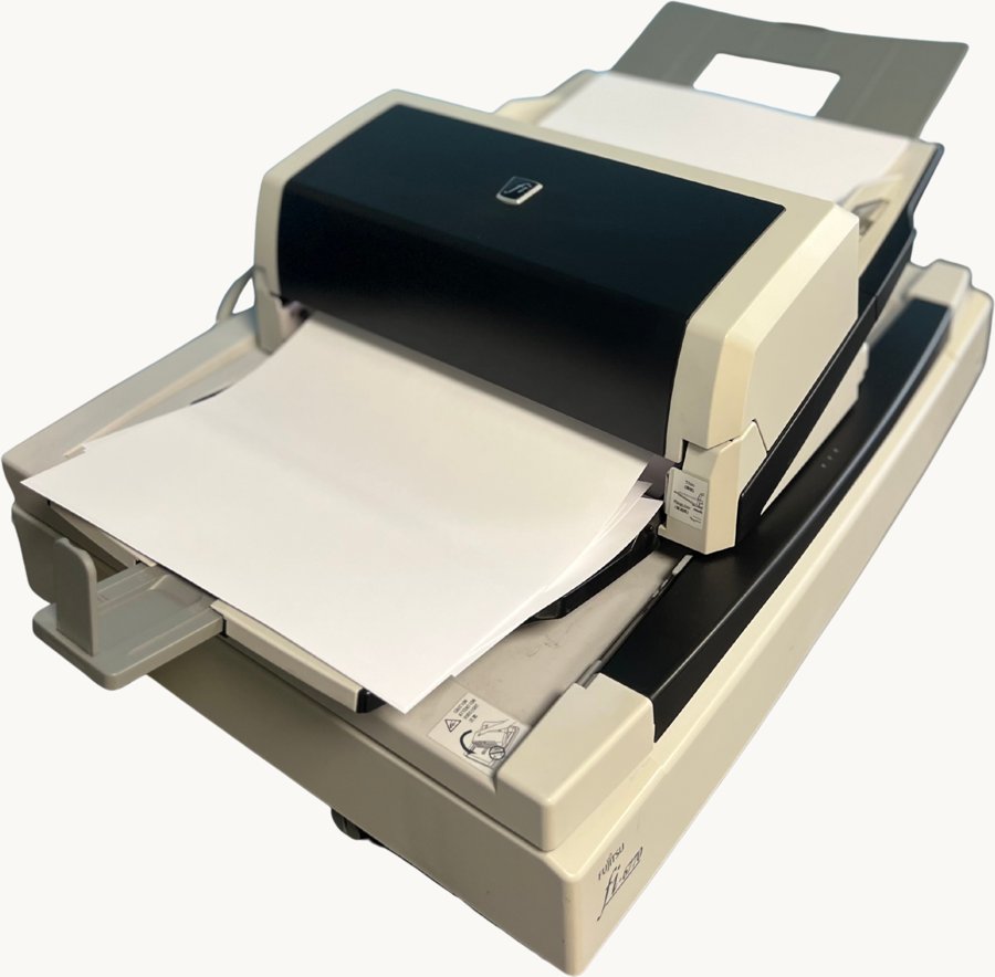 A production document scanner feeding a stack of A4 pages